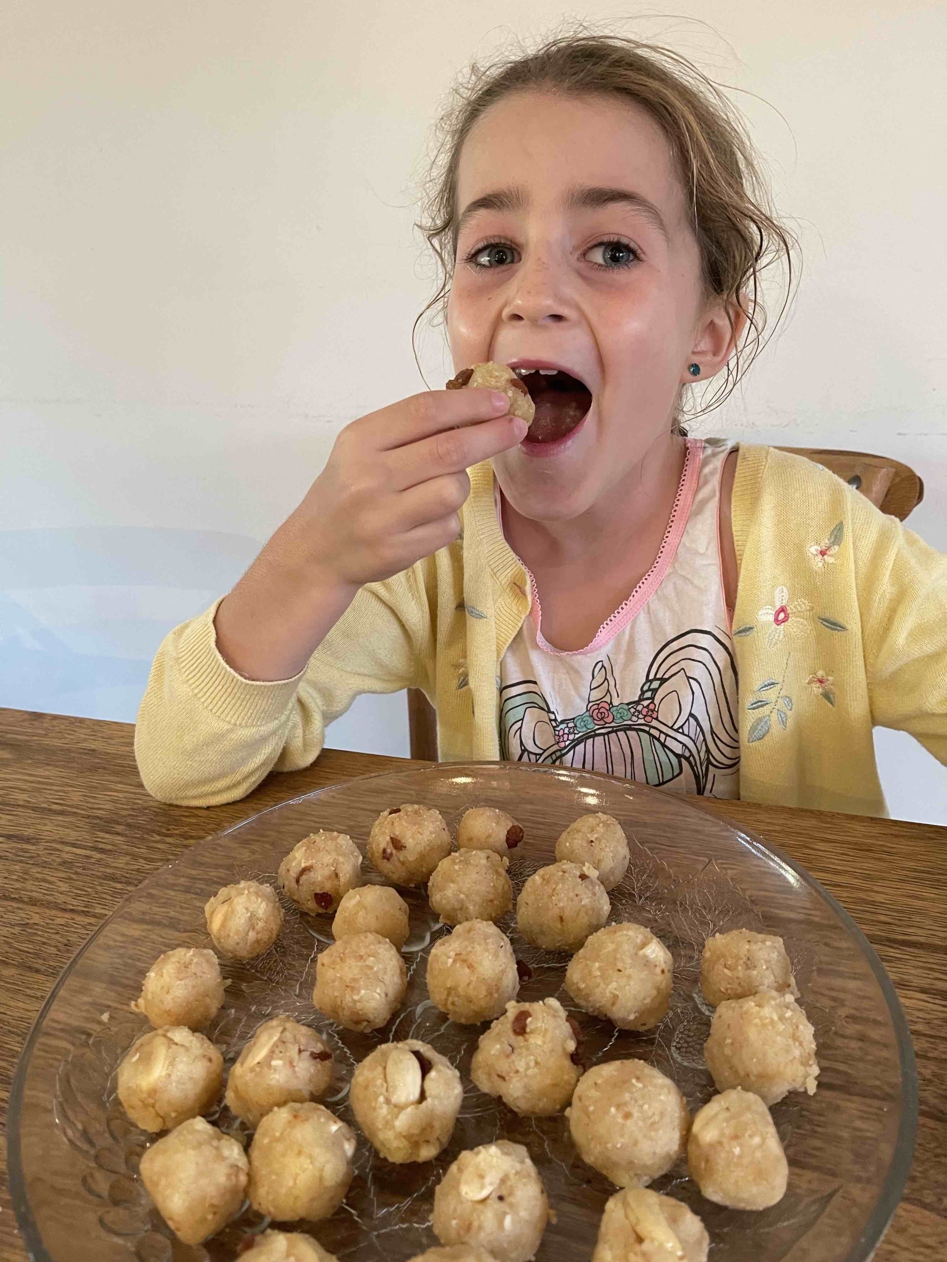 Elva taste testing some homemade ladoo :)